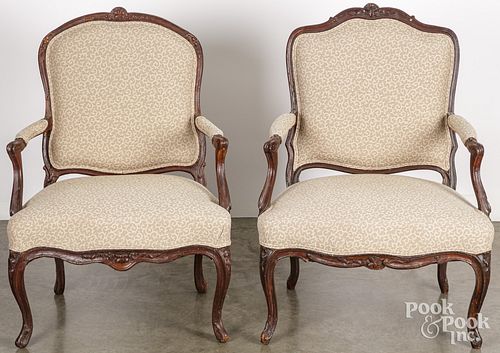 Pair of French carved walnut upholstered armchairs