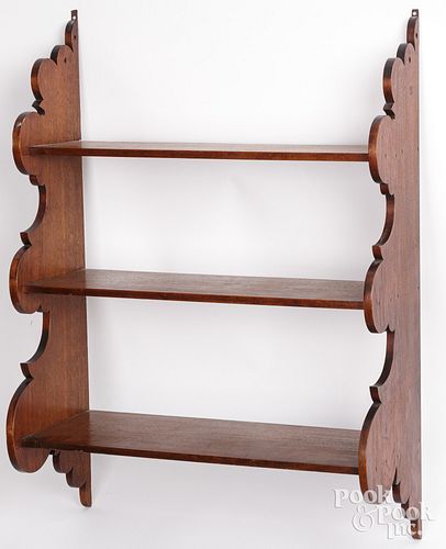 Walnut hanging shelf, 19th c., with scalloped side