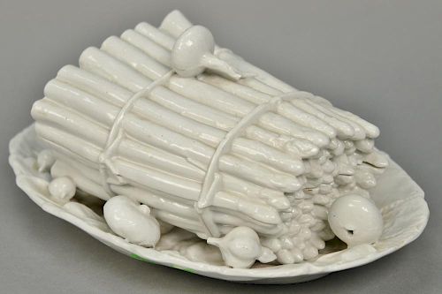 White porcelain asparagus tureen with cover having naturalistically modeled asparagus tied with twine surrounded with shallot