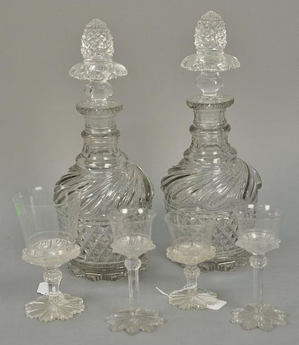 Six piece lot with two Anglo Irish decanters with stoppers and four various cut crystal stems in three sizes with etched fleu