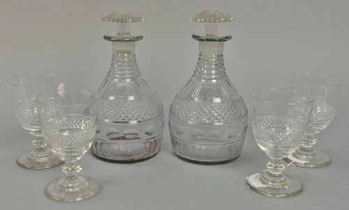 Six piece lot to include pair of crystal decanters and four stems all with petal style bases. decanter: ht. 9in., stems: ht. 