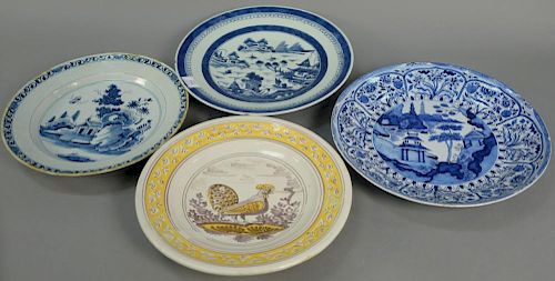 Four piece lot to include two Delft chargers (one 18th century), one Canton charger, and one earthenware charger (rim chips a