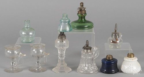 Ten assorted glass fluid lamps.