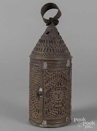 Punched tin lantern, 19th c., the door decorated with a whimsical face, 15'' h. Provenance: The colle