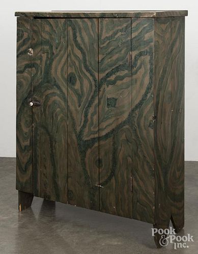 New England painted pine cupboard, 19th c., retaining a later green swirl decoration, 49'' h., 38'' w.