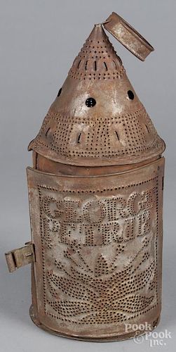 Punched tin lantern, 19th c., inscribed George Petrie, with line and dot decoration and a human fa