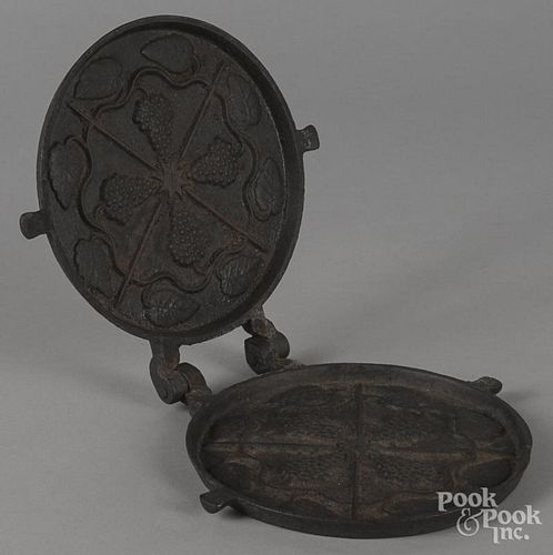 Cast iron waffle iron, 19th c., with grape bunch design, 7 1/2'' dia.