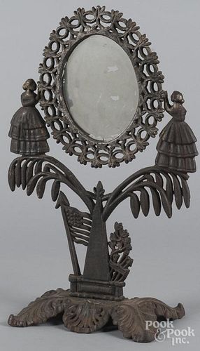 Cast iron dressing mirror, late 19th c., with two female figures flanking the mirror, above an Ameri
