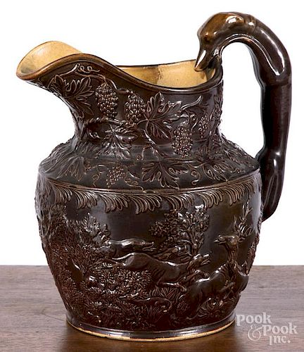 American Pottery Co., Jersey City, New Jersey, molded pottery pitcher with hound handle and relief h