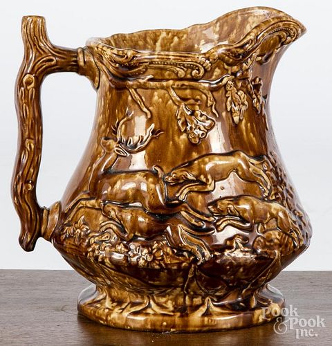 Rockingham glaze pitcher, 19th c., probably New Jersey, with relief hunting scene, 9'' h.