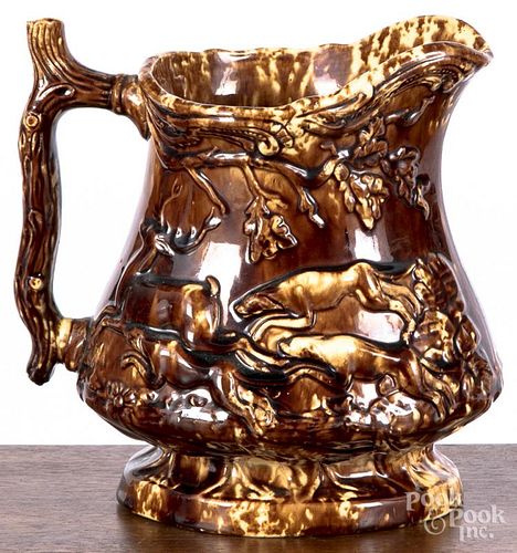 Rockingham glaze pitcher, 19th c., probably New Jersey, with relief hunting scene, 8 1/4'' h.
