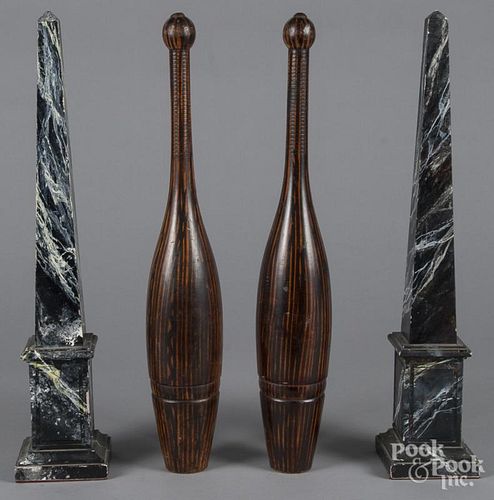 Pair of painted juggling pins, together with a pair of faux marble obelisks, 21'' h.