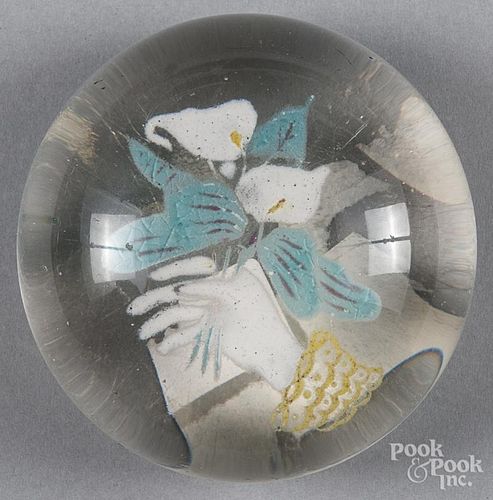Colored frit paperweight, with a hand holding lilies, 3 1/2'' dia.