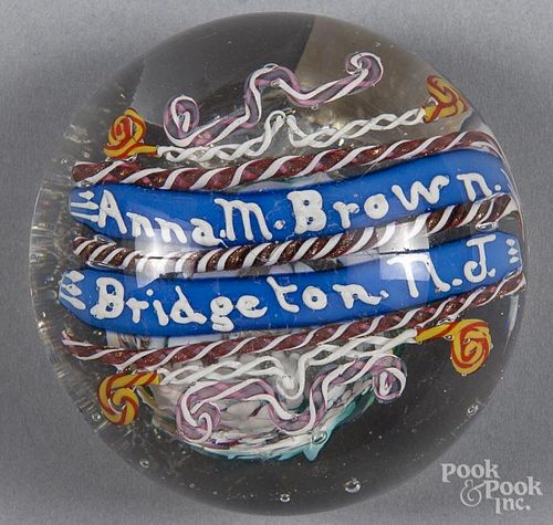 Multicolored name paperweight, with intricate lampworked shapes above and below the inscription Ann