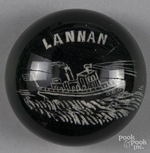White frit paperweight, with a tugboat, inscribed Lannan on a translucent green ground, 3 1/4'' dia
