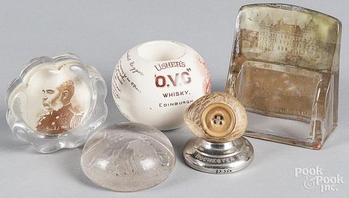 Five assorted paperweights, to include advertising and military weights of various materials.
