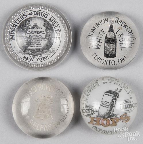 Four circular advertising paperweights, largest - 3 1/2'' dia.