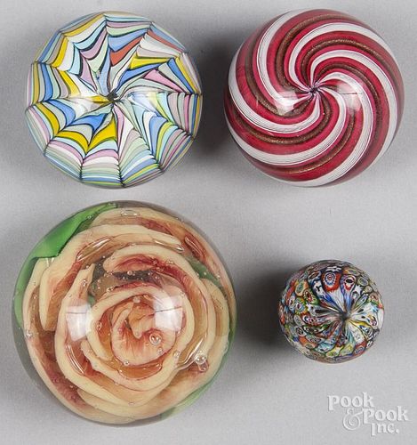 Four Murano paperweights, to include an orange rose and a small millefiori hand cooler, largest - 3