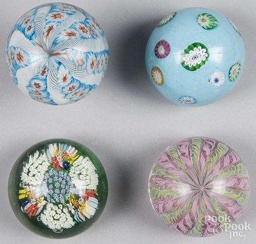 Four assorted paperweights, to include a crown patterned pedestal and a millefiori flower garden wei