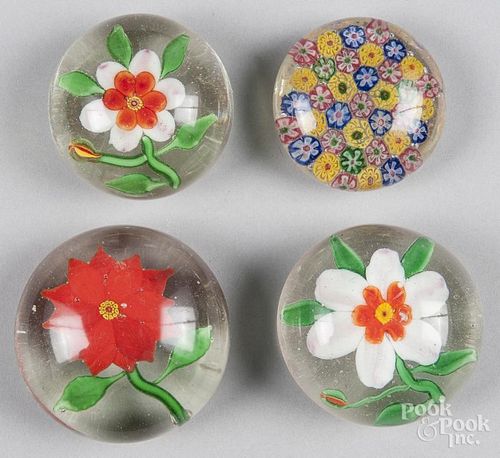 Four Chinese paperweights, ca. 1930, to include three flowers and a millefiori, largest - 3'' dia.