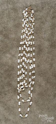 Four strand baroque pearl necklace with yellow gold clasp and beads, unmarked, 22'' - 28'' l.