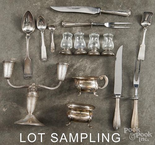 Group of silver, to include coin spoons, pair of weighted candelabra, etc.