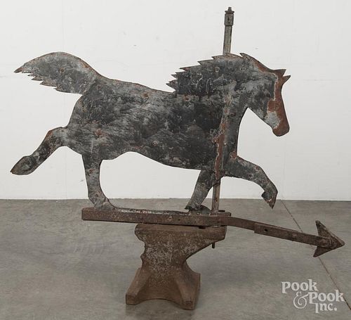 Large sheet iron horse weathervane, 19th c., with a make - do anvil stand, 32'' h., 42'' l.