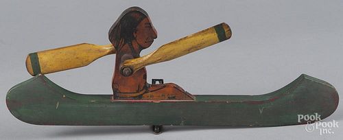 Painted pine Native American Indian in a canoe whirligig, 20th c., 17 '' l.