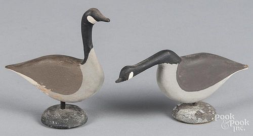 Pair of miniature carved and painted Canada goose decoys, 20th c., on a mounded lead base, 5'' h. and