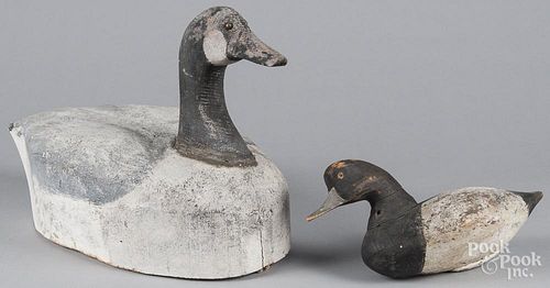 Carved and painted Canada goose decoy, mid 20th c., with balsa body, 21'' l., together with a carved