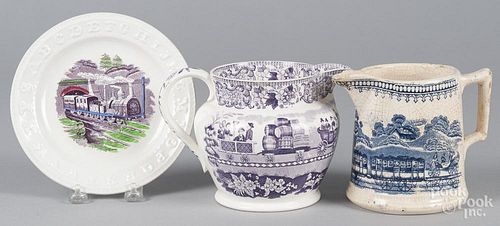 Three pieces of Staffordshire, 19th c., with transfer decoration of trains, the purple pitcher inscr