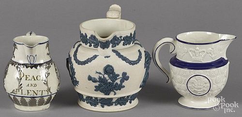 Three Staffordshire pitchers, 19th c., one with lustre decoration of King George III, the largest wi