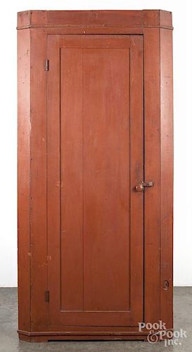 Pennsylvania painted poplar one - piece corner cupboard, 19th c., retaining an old red surface, 78 1