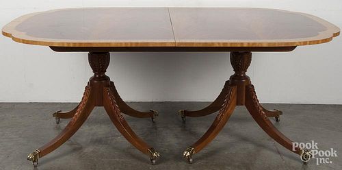 Baker Federal style mahogany dining table with three 16 1/4'' leaves, 28 1/2'' h., 46'' w., 70'' d.