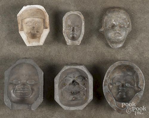 Five Martha Chase doll head molds, late 19th c., four are lead and one plaster, largest - 5 1/2'' h.