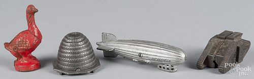 Four cast iron still banks, to include a Graf Zeppelin, 6 3/4'' l., bee skep, 2 1/2'' h., Red Goose