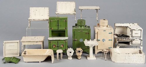 Sixteen pieces of Arcade and Hubley cast iron dollhouse furniture, to include dining tables, benches