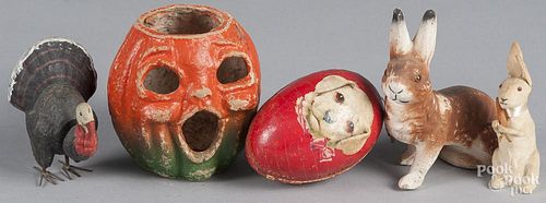 Four composition holiday candy containers, to include a turkey, a rabbit, an egg with rabbit and dog