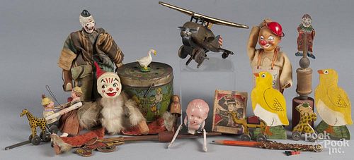 Group of miscellaneous toys, to include a tin wind-up airplane, an animated clown on wood base, a ce