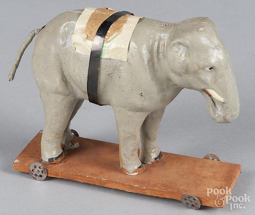 German composition elephant pull toy on a wood platform, 6'' l.