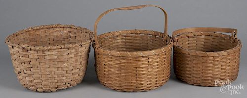 Three split oak baskets, largest - 13'' h., 14'' w.