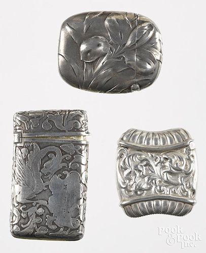 Three match vesta safes, to include one Gorham sterling with embossed flower, 1 3/4'' h., one Wallace