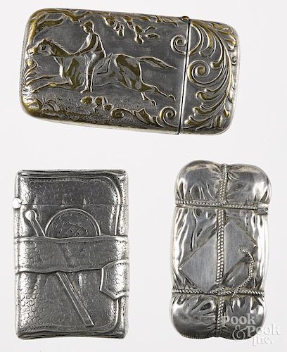 Three match vesta safes, to include a sterling silver example of a wallet with a match stick and a d