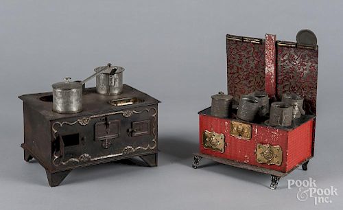 Two American tin toy stoves, with miscellaneous tin cookware, 12 3/4'' h. and 6 1/2'' h.
