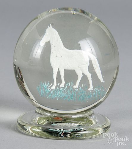 Upright footed frit paperweight, attributed to Michael Kane, with a white horse and blue grass, 3 1/