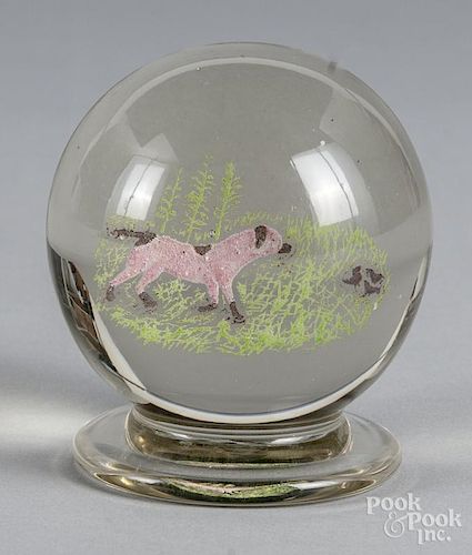 Footed and colored upright frit paperweight, attributed to Michael Kane, with a hunting dog and quai