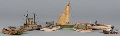 Six painted wood toy boats, three with composition figures, one with a Native American Indian in a c