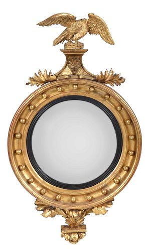 A Classical Carved Giltwood and Parcel Ebonized Bullseye Mirror