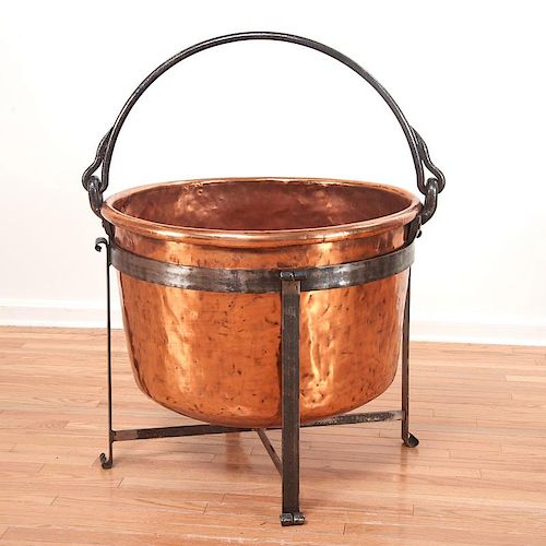Large copper cauldron on wrought iron stand