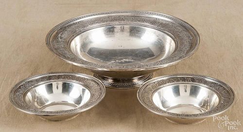 Three sterling silver bowls with an elaborate floral vine border, largest - 3'' h., 10 1/2'' dia.